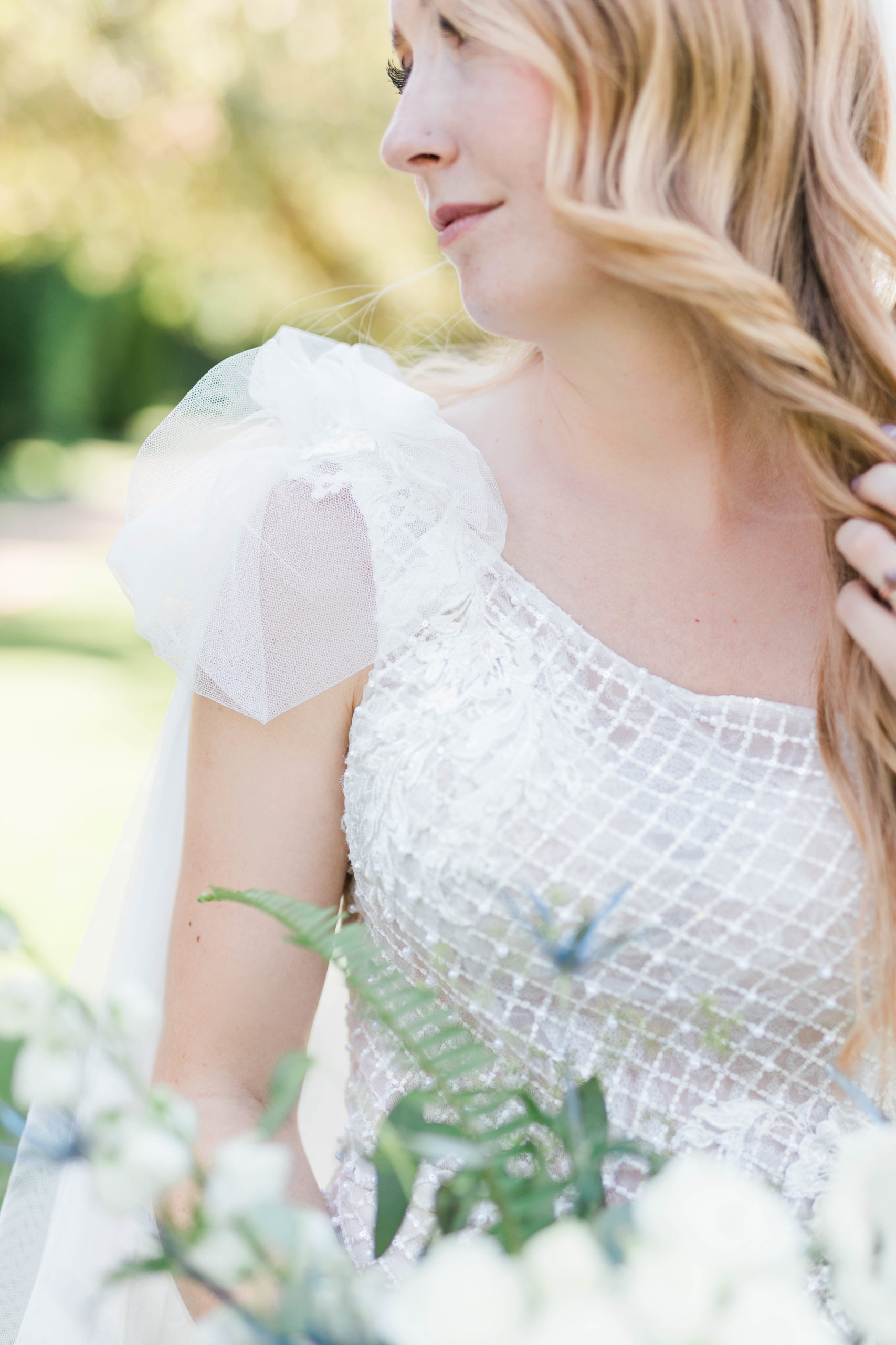 detail of bridal dress with a crystal top and puff sleeves