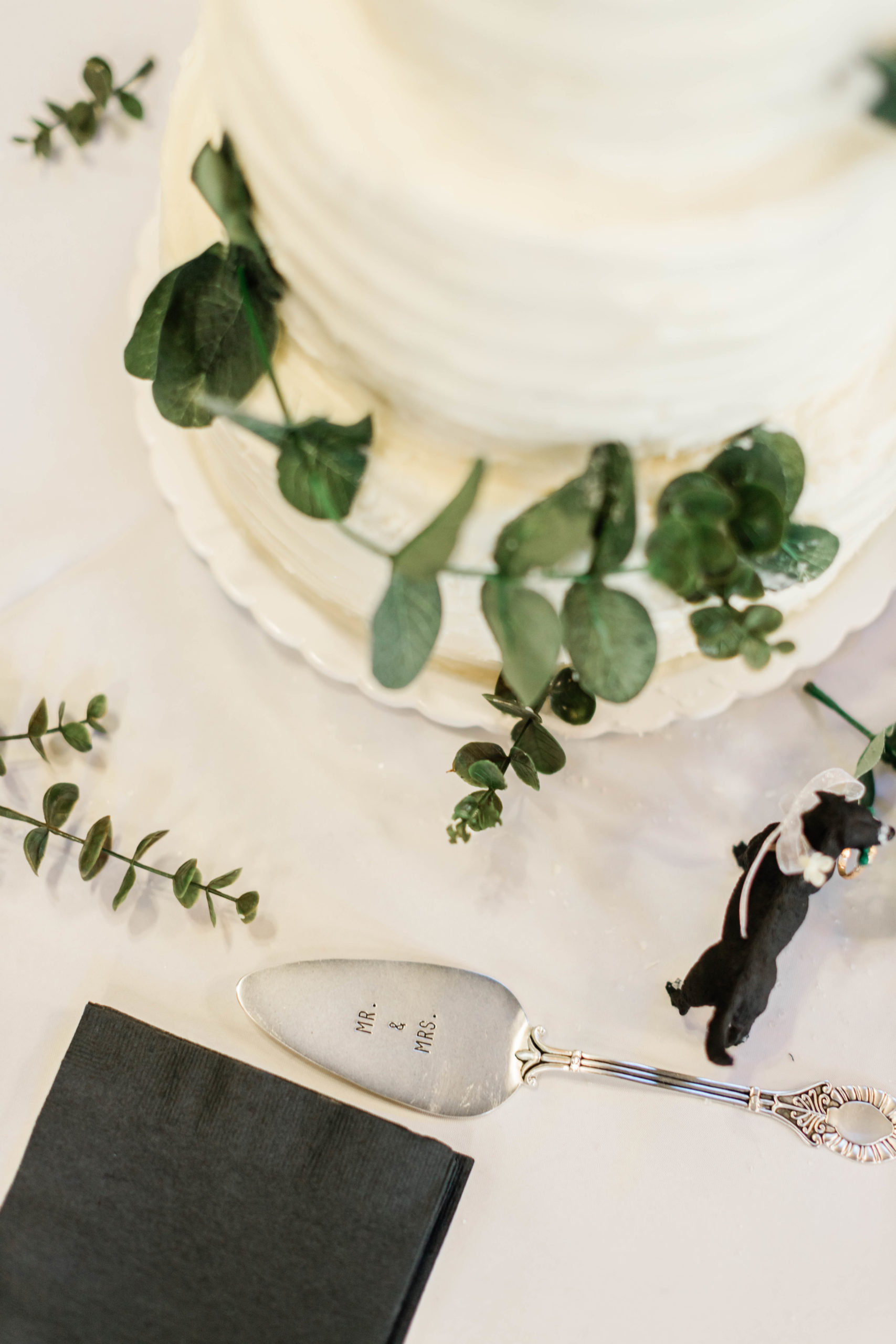 white buttercream wedding cake with little dog figurines