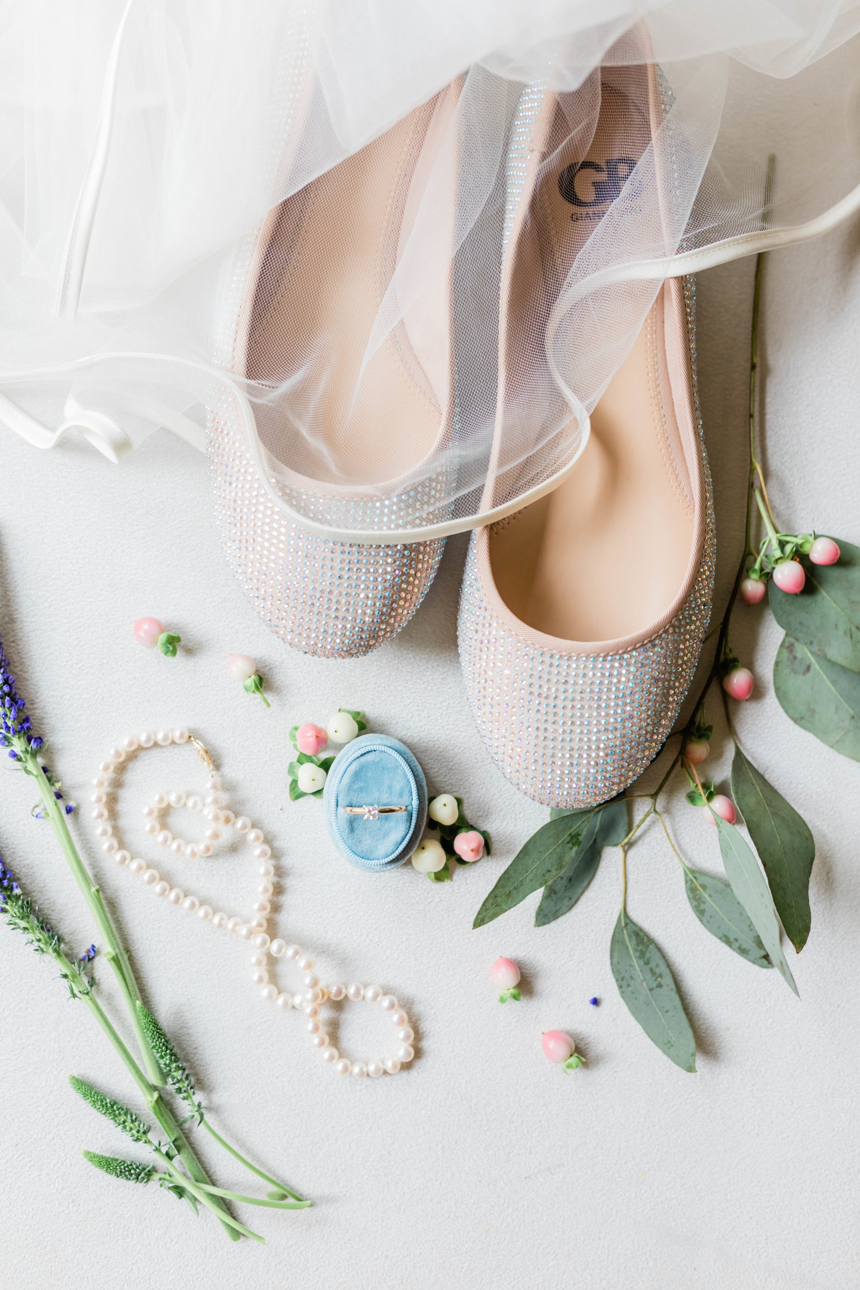 bridal details with greenery, jewelry and shoes