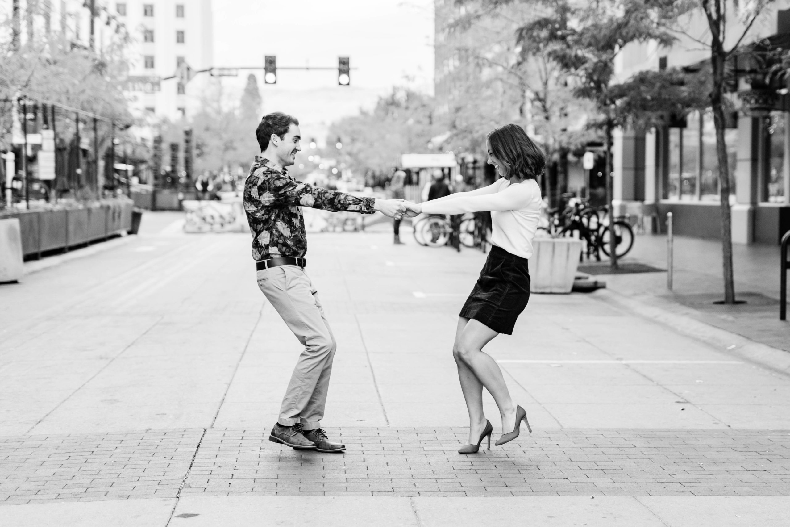 Boise wedding photographer captures man and woman dancing in downtown boise streets