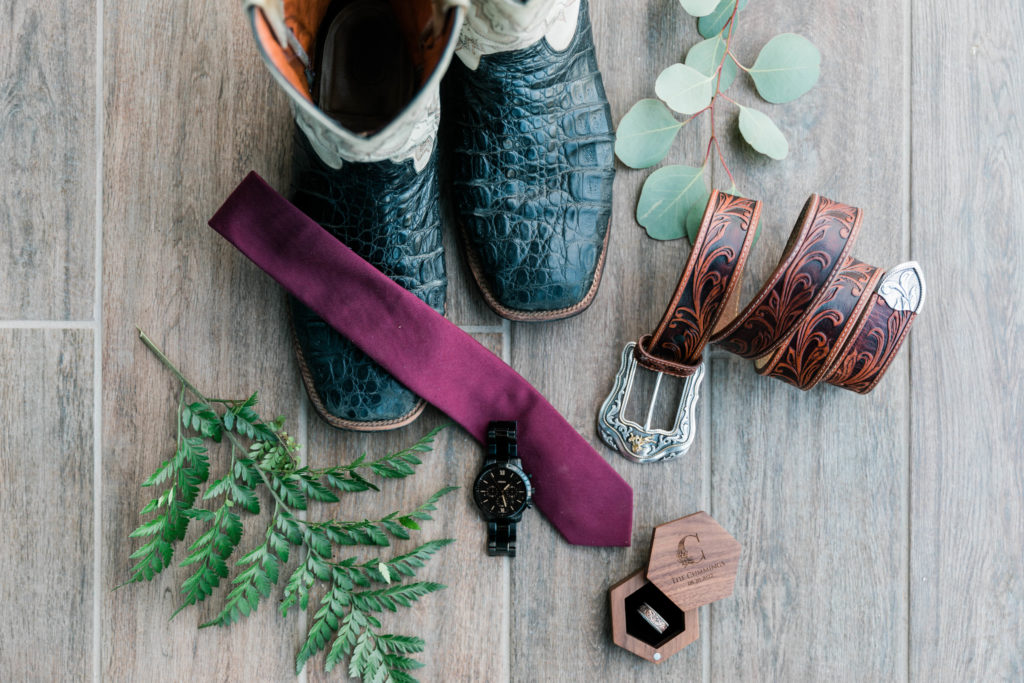 close up of groom details with cowboy boots 