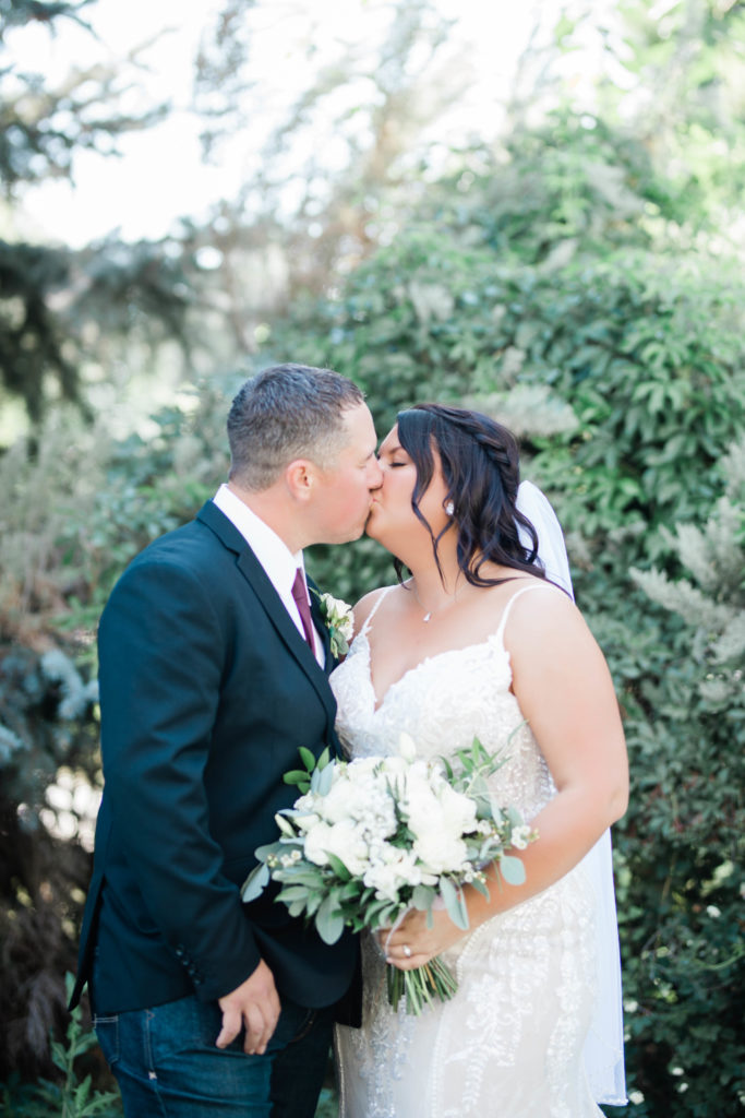 Boise wedding photographer captures bride and groom kissing after first look