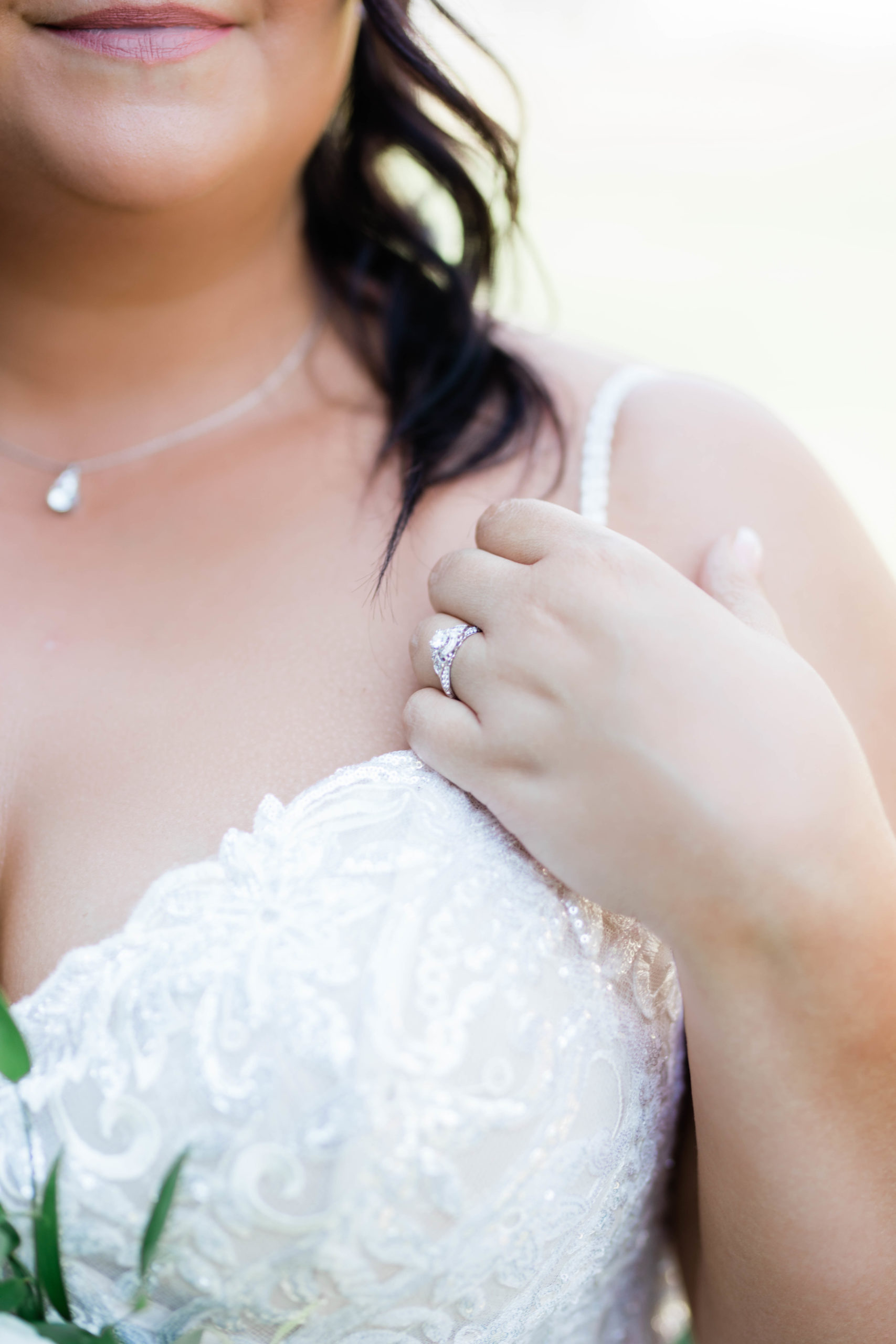 Boise wedding photographer captures bride touching sleeve and showing engagement ring