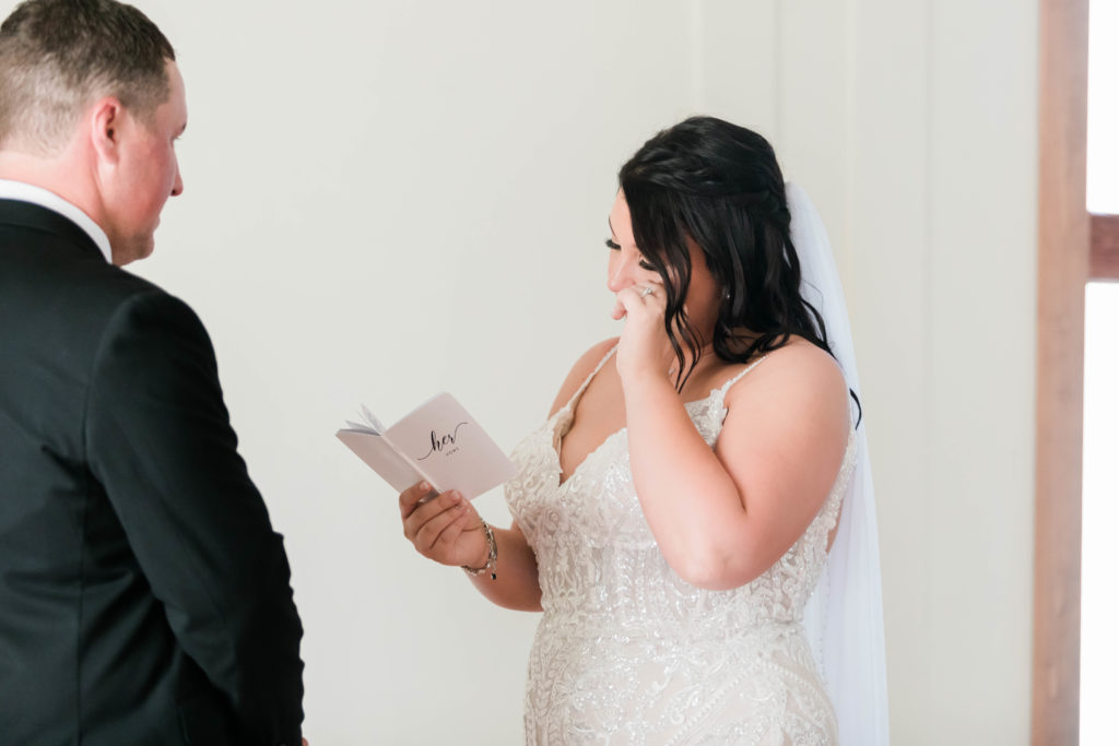 Boise wedding photographer captures bride reading vows before wedding ceremony to groom