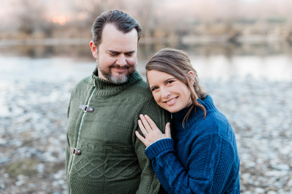 Boise wedding photographer captures woman hugging man's arm during outdoor engagement session