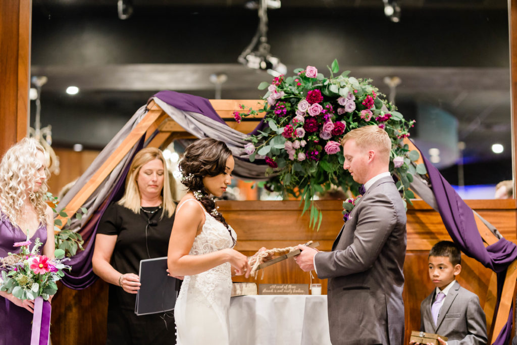 Boise wedding photographer captures bride and groom standing at alter during boise unplugged wedding ceremony