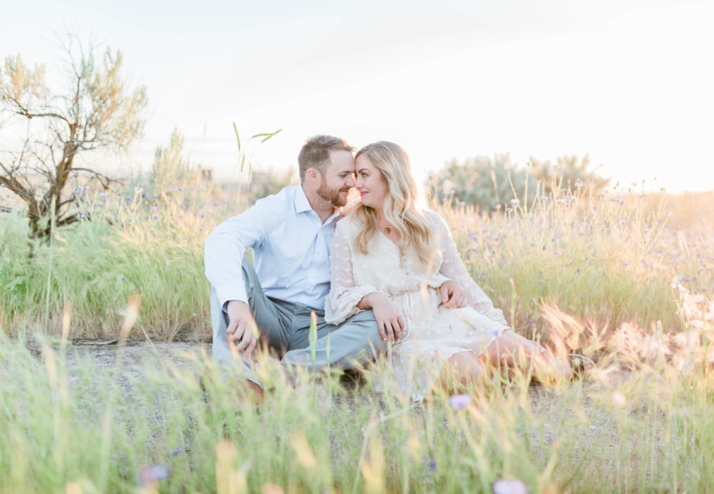 couple sitting together during golden hour engagements