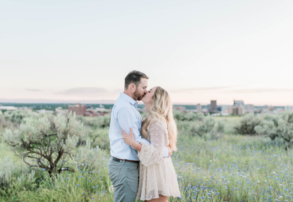 Boise wedding photographer captures couple kissing after working through top 6 essential things to do after getting engaged