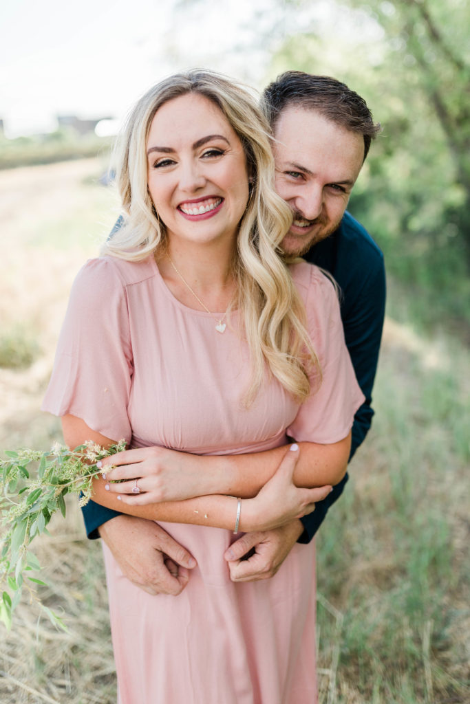 Boise wedding photographer captures couple embracing during joyful engagement photos
