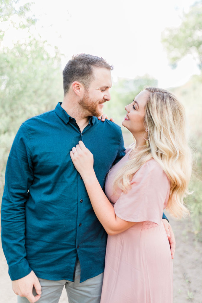 woman looking at man during joyful engagement photos in boise