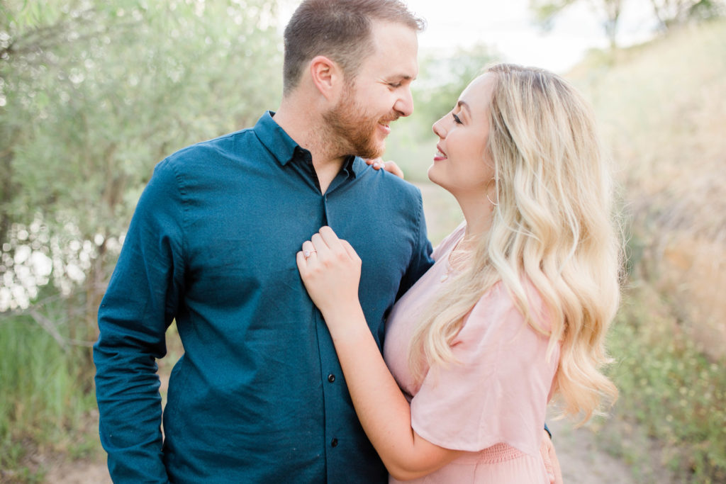 Boise wedding photographer captures couple embracing during joyful spring engagement photos