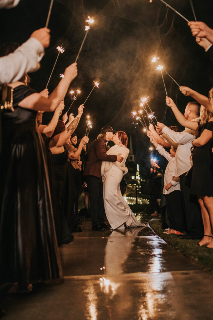 Boise wedding photographer captures couple kissing during sparkler exit