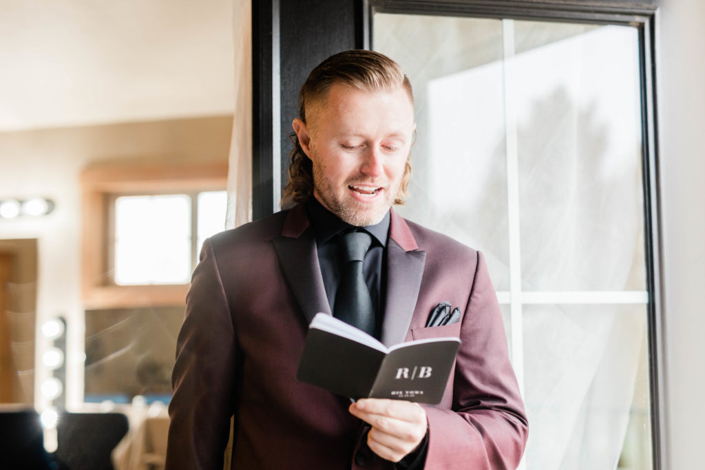 Boise wedding photographers capture groom reading vows during private vow reading