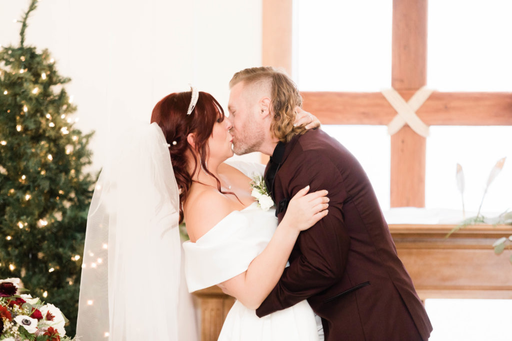 bride and groom kissing at Still Water Hollow wedding ceremony