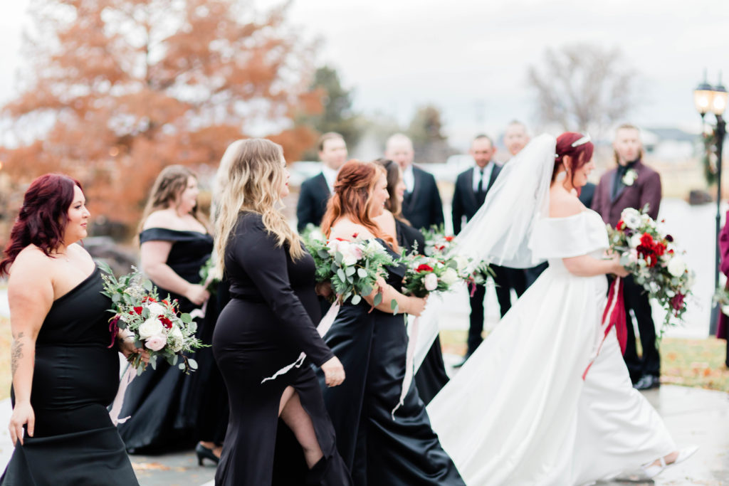 Boise wedding photographer captures bride walking with bridesmaids in Still Water Hollow wedding
