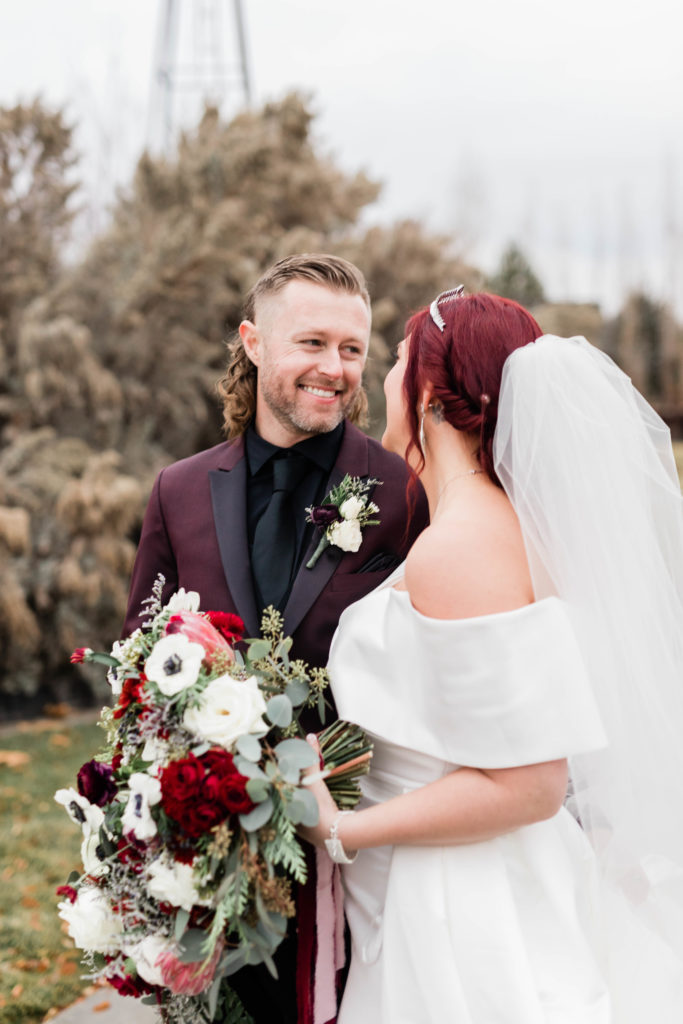 Boise wedding photographer captures groom smiling at bride