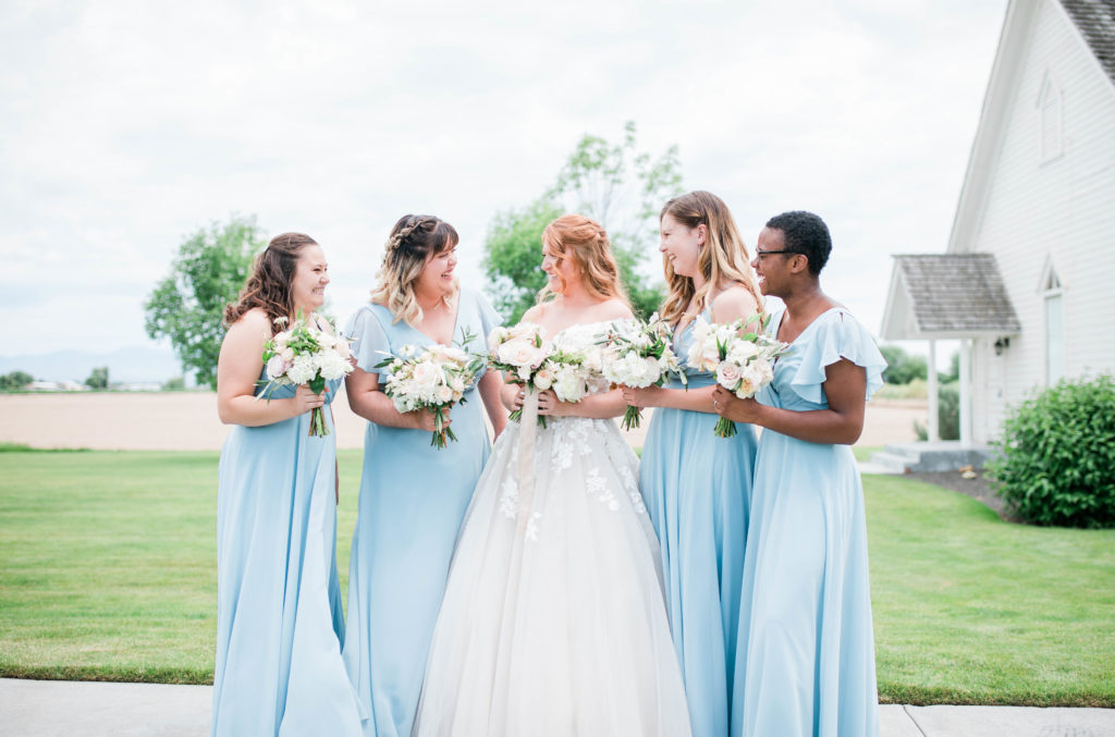 Boise wedding photographer captures bride and bridesmaids looking at one another