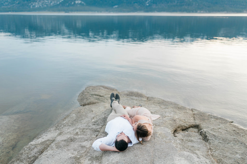 Boise wedding photographer captures couple laying on rock 