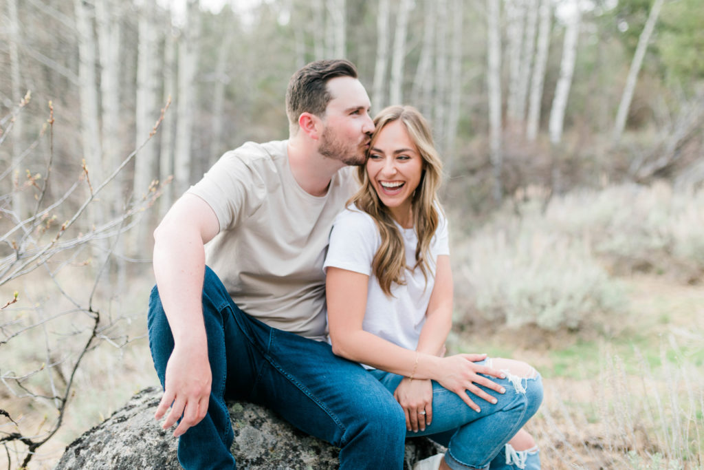 Boise wedding photographer captures man and woman sitting on rock together