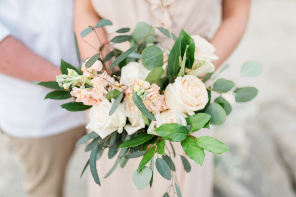 Boise wedding photographer captures close up of blush flowers and greenery bouquet