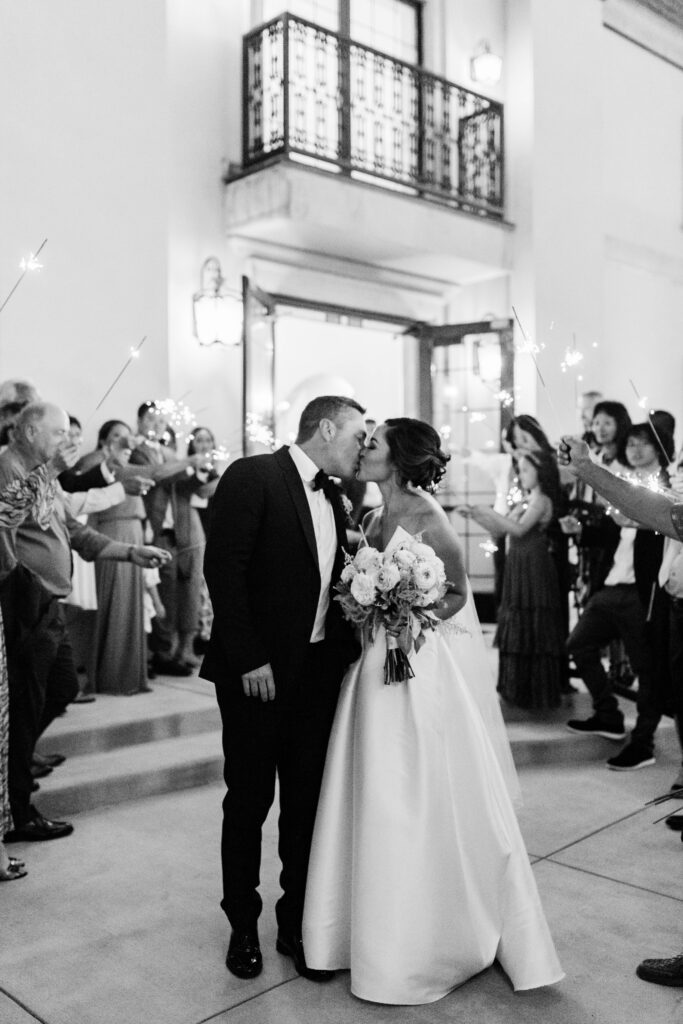 Boise wedding photographers capture bride and groom kissing after wedding ceremony
