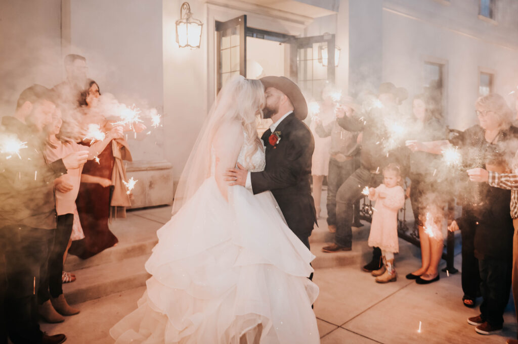 Boise wedding photographers capture couple celebrating recent marriage during sparkler wedding exit