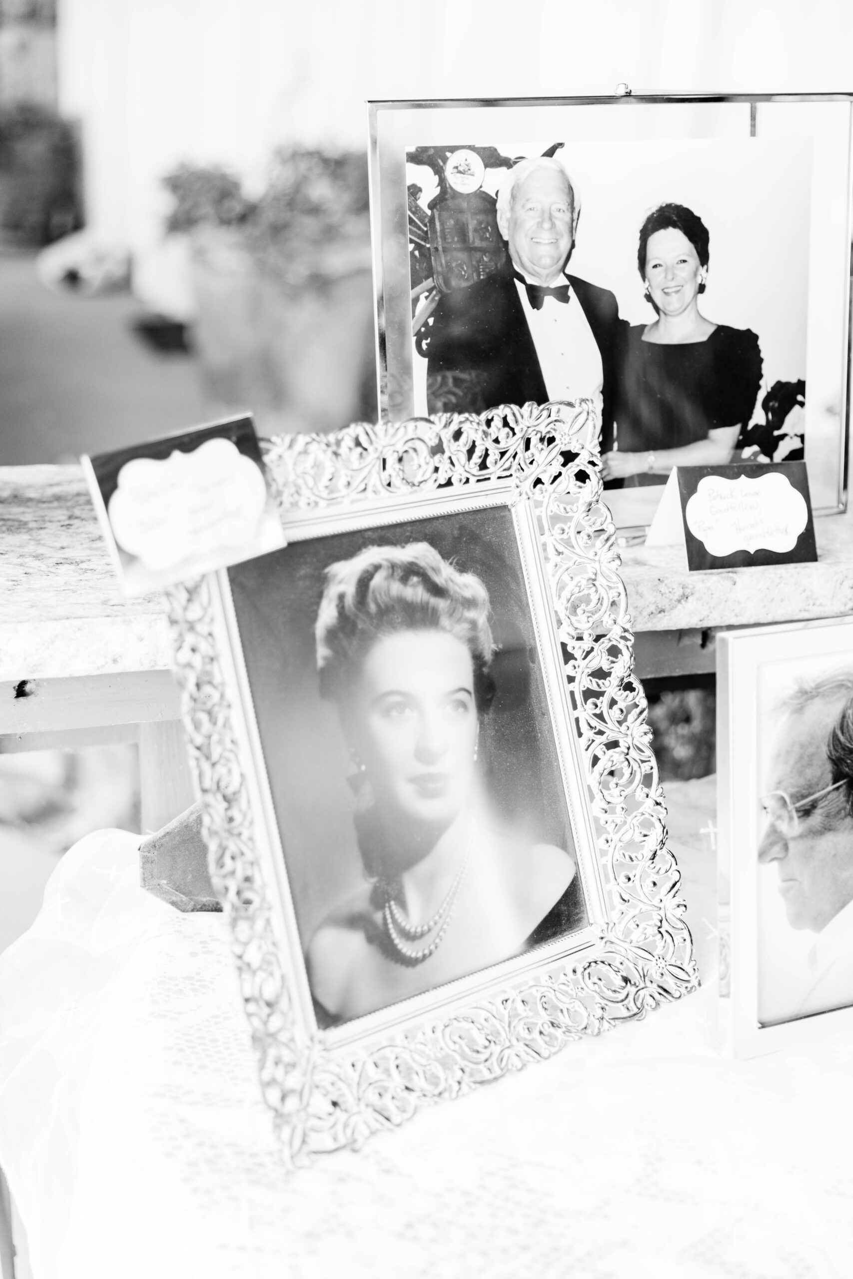 Boise wedding photographers capture black and white portrait of framed pictures of family members at wedding