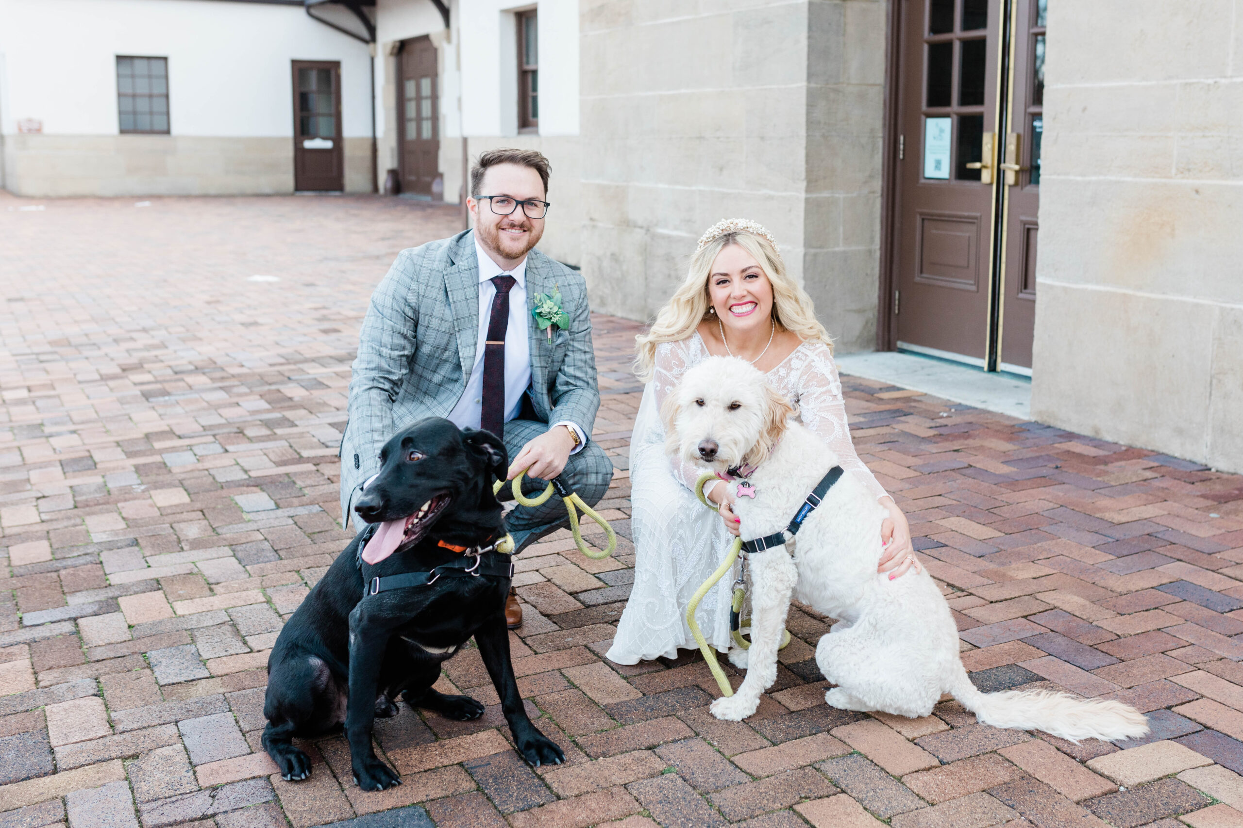 Boise wedding photographer captures bride and groom standing with pets after including them in Boise wedding