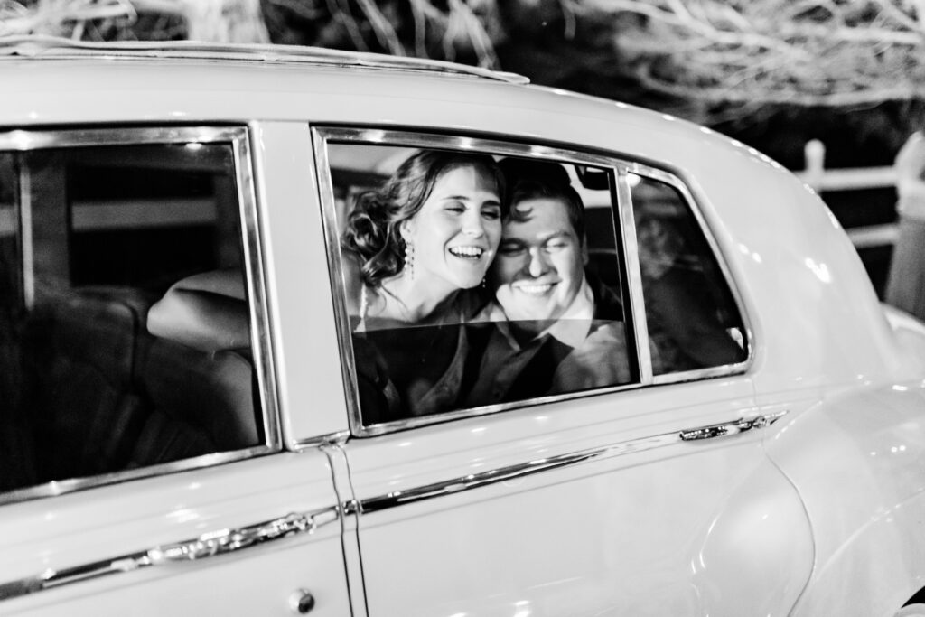 Boise wedding photographers captures couple saying goodbye in vintage car
