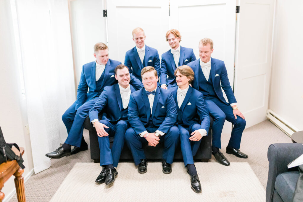 Boise wedding photographers capture groom with groomsmen in blue suits