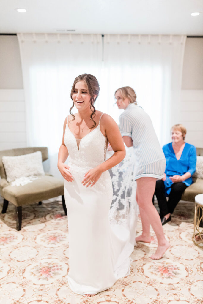Boise wedding photographer captures bride getting into wedding dress before ceremony