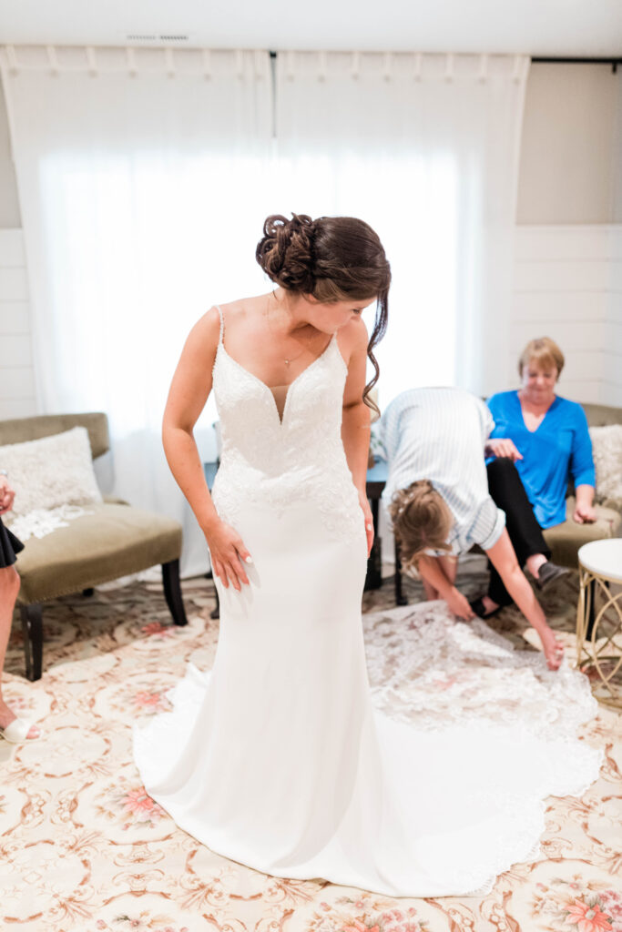 Boise wedding photographers capture bride fluffing out wedding gown before Fox Canyon Vineyards wedding