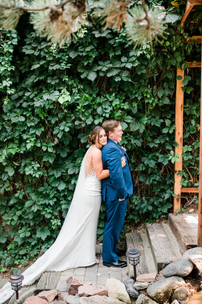 Boise wedding photographers capture bride holding groom before first look