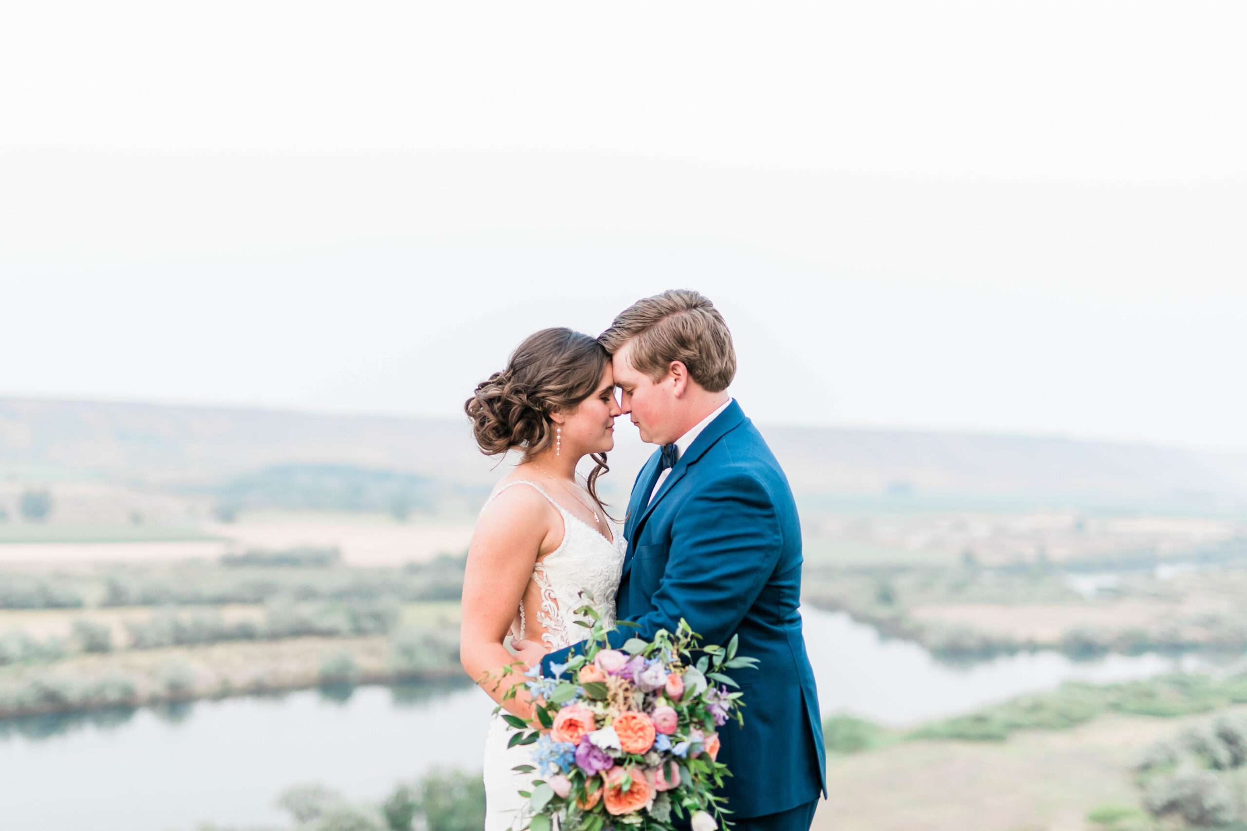 Boise wedding photographers capture couple embracing after Fox Canyon Vineyards wedding ceremony