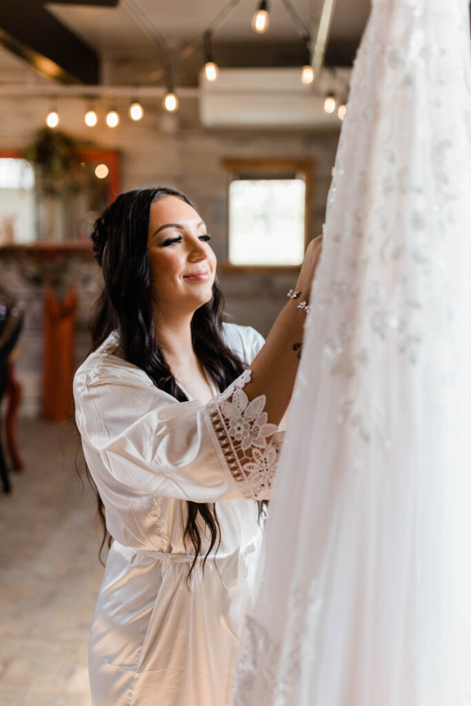 Boise wedding photographer captures bride looking at wedding dress
