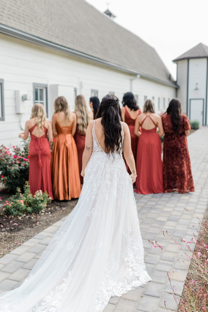Boise wedding photographer captures bride walking up to bridesmaids for first look
