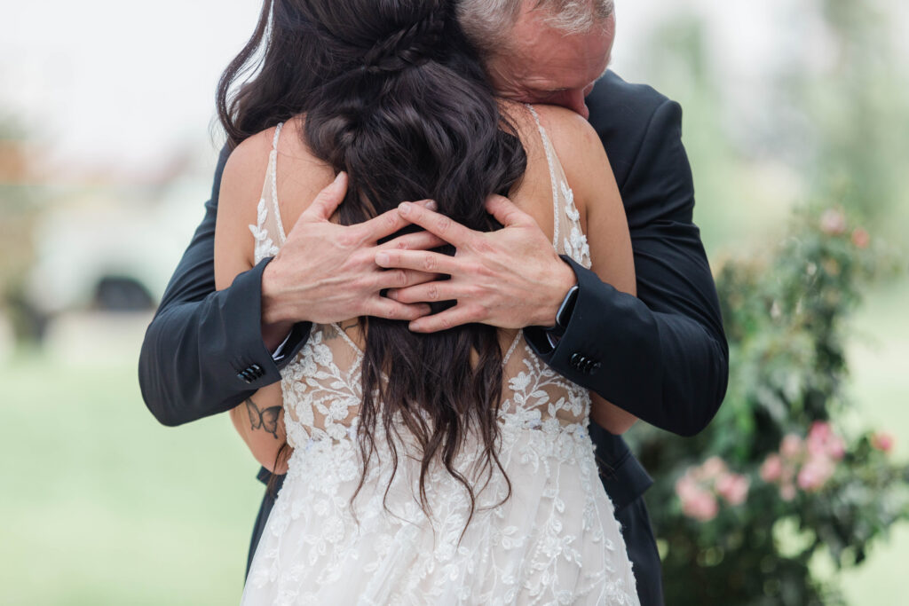 Boise wedding photographer captures bride hugging father after first look