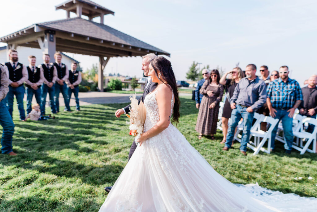 Boise wedding photographer captures bride being walked down aisle