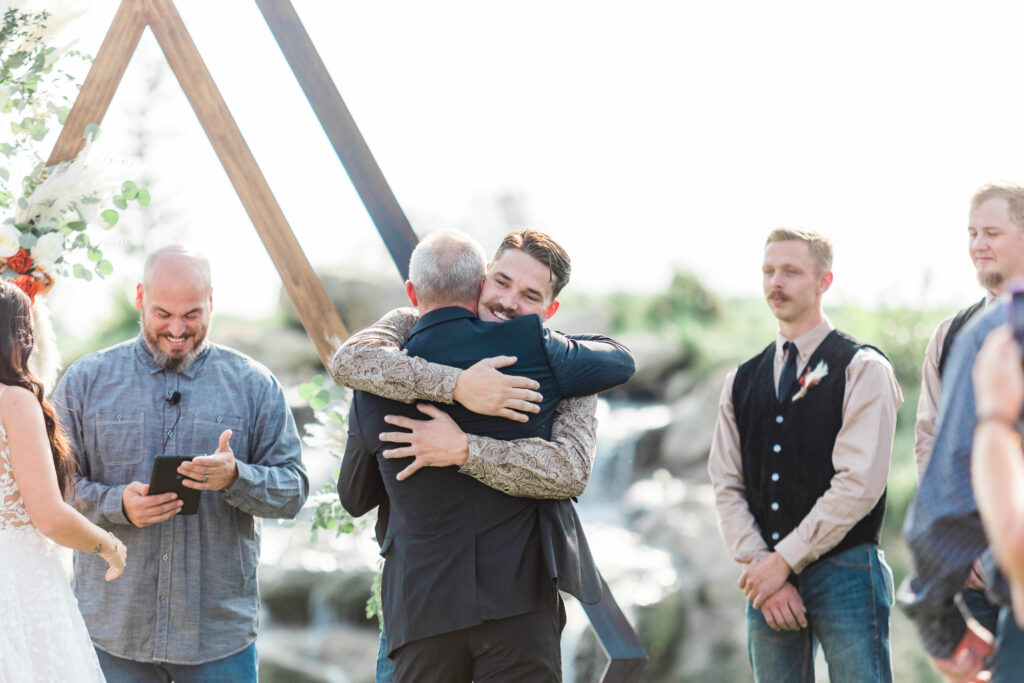 Boise wedding photographer captures groom hugging bride's father 