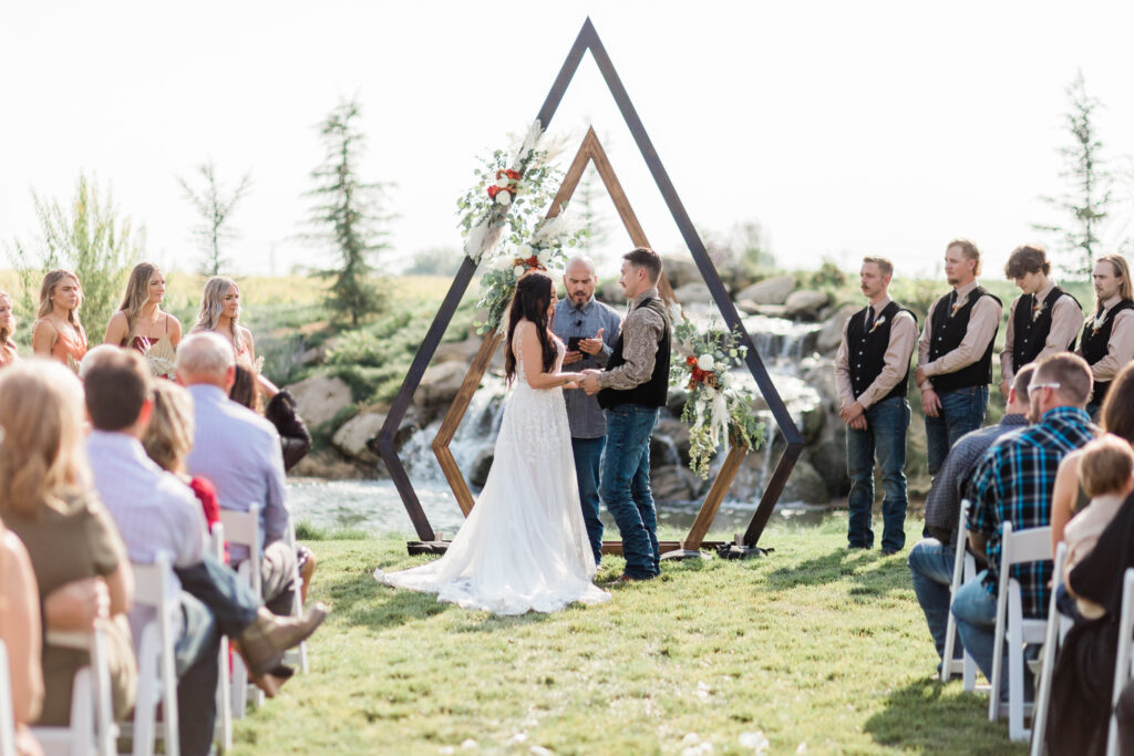 Boise wedding photographer captures bride and groom at alter during outdoor wedding ceremony