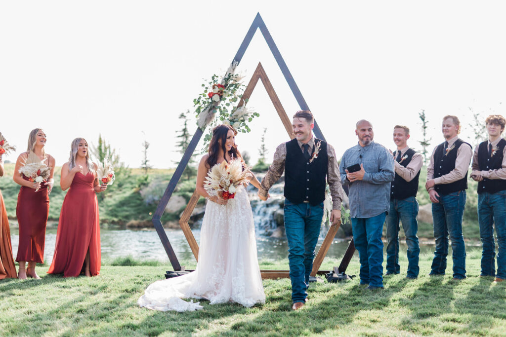 Boise wedding photographer captures couple exiting outdoor wedding ceremony