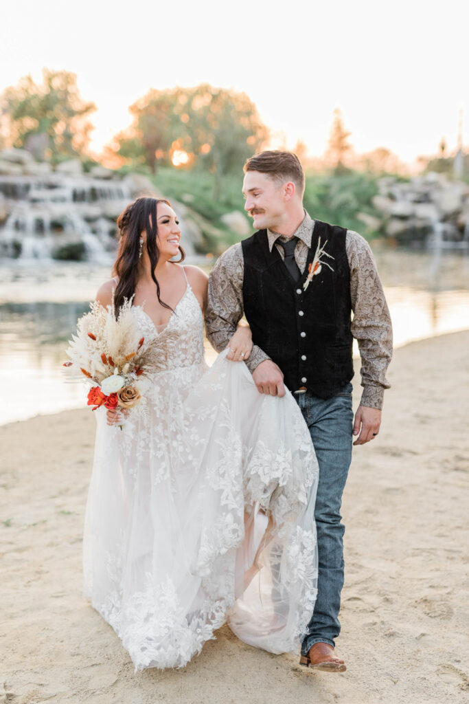 Boise wedding photographer captures bride and groom walking in sand