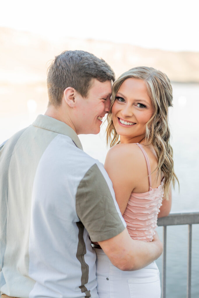 Boise wedding photographer captures woman looking over shoulder while man hugs her